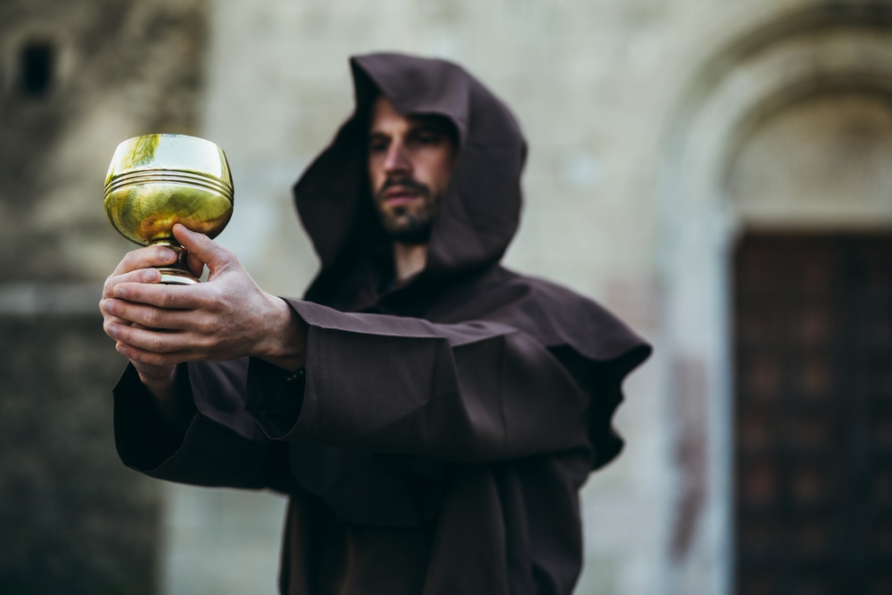 Picture of a monk holding the holy grail which is like a business knowing how to predict customer churn